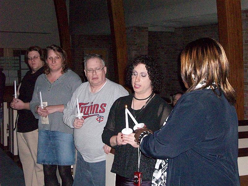100_0210.JPG - Participants pledge to never let the light of those individuals who have died in anti-transgender violence go out, as they pass on the symbolic flame